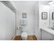 Bathroom featuring a toilet, a shower with white tile, and an elegant vanity at 809 Kings Ct, Punta Gorda, FL 33950