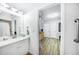 Bathroom with white cabinets, a stylish sink, and wood-look tile flooring at 809 Kings Ct, Punta Gorda, FL 33950