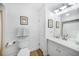 Clean bathroom with a white vanity, a toilet, and stylish tile flooring at 809 Kings Ct, Punta Gorda, FL 33950