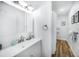 Bright bathroom with a white vanity, framed art and a shower behind a shower curtain at 809 Kings Ct, Punta Gorda, FL 33950
