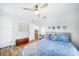 Cozy bedroom featuring a wooden ceiling fan, wood floors and stylish nautical themed decor at 809 Kings Ct, Punta Gorda, FL 33950