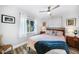 Bright bedroom with a ceiling fan, wood-look tile floor, and stylish bedding at 809 Kings Ct, Punta Gorda, FL 33950