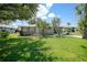 Exterior view of the home with vibrant green lawn, complemented by the home's neutral color scheme at 809 Kings Ct, Punta Gorda, FL 33950