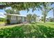 Charming home exterior with a well-manicured lawn, tidy landscaping, and a quaint blue front door at 809 Kings Ct, Punta Gorda, FL 33950
