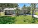 Exterior view of the home featuring a lush green lawn and tidy landscaping at 809 Kings Ct, Punta Gorda, FL 33950