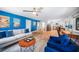 Inviting living space featuring wood-look floors, blue accent wall, comfortable seating, and an adjacent kitchen at 809 Kings Ct, Punta Gorda, FL 33950