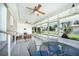 Bright sunroom with ceiling fans and ample seating space overlooking the backyard at 809 Kings Ct, Punta Gorda, FL 33950