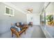 Inviting sunroom with ceiling fan, comfortable seating, and views of the outdoor area at 809 Kings Ct, Punta Gorda, FL 33950