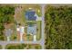 Aerial view of the property highlighting the pool, landscaping, and surrounding neighborhood at 13297 Flaherty Ave, Port Charlotte, FL 33981