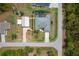 Bird's-eye view of a well-maintained home with a large yard, pool, and detached garage at 13297 Flaherty Ave, Port Charlotte, FL 33981