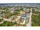 Beautiful aerial view of the featured home with lush landscaping in a desirable neighborhood at 13297 Flaherty Ave, Port Charlotte, FL 33981