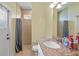 Bright bathroom featuring a granite countertop, a toilet and a tiled shower with curtain at 13297 Flaherty Ave, Port Charlotte, FL 33981