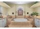 Elegant bathroom with tiled platform tub, granite countertops, and decorative accents at 13297 Flaherty Ave, Port Charlotte, FL 33981