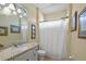 Well-maintained bathroom featuring a vanity with granite countertop and a shower with white curtain at 13297 Flaherty Ave, Port Charlotte, FL 33981