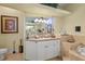 Bright bathroom with granite countertops, a large mirror, and decorative accents at 13297 Flaherty Ave, Port Charlotte, FL 33981
