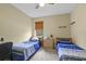 Bright bedroom with two twin beds, natural light, and neutral decor at 13297 Flaherty Ave, Port Charlotte, FL 33981