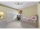 Comfortable bedroom featuring a bed, closet, and desk with natural light from a window at 13297 Flaherty Ave, Port Charlotte, FL 33981