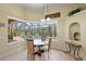Breakfast nook with a pool view, round table, and modern light fixture at 13297 Flaherty Ave, Port Charlotte, FL 33981