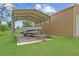 Carport structure beside a detached garage, offering covered parking for a boat or other vehicles at 13297 Flaherty Ave, Port Charlotte, FL 33981