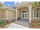 Inviting front entrance featuring double doors, decorative columns, and stone landscaping at 13297 Flaherty Ave, Port Charlotte, FL 33981
