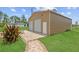Spacious detached garage with two roll-up doors, offering ample space for storage and projects at 13297 Flaherty Ave, Port Charlotte, FL 33981