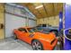 Garage interior featuring a car lift, ample parking space, and tool storage for the automotive enthusiast at 13297 Flaherty Ave, Port Charlotte, FL 33981