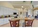 Open kitchen featuring granite countertops, white cabinets, and a breakfast bar with seating at 13297 Flaherty Ave, Port Charlotte, FL 33981
