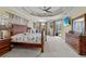 Expansive bedroom features tray ceiling, large bed, view to pool, and elegant furniture at 13297 Flaherty Ave, Port Charlotte, FL 33981