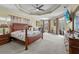 Spacious bedroom with tray ceiling, a large bed, and an abundance of natural light at 13297 Flaherty Ave, Port Charlotte, FL 33981