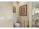 Cozy powder room with decorative art and a modern toilet at 13297 Flaherty Ave, Port Charlotte, FL 33981