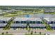 An aerial view of community, highlighting landscaping, lake, and building architecture at 14267 Heritage Landing Blvd # 1223, Punta Gorda, FL 33955