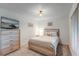 Cozy bedroom featuring neutral walls, a queen bed, and a dresser with a TV at 14267 Heritage Landing Blvd # 1223, Punta Gorda, FL 33955