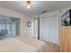 Bright bedroom featuring a large window, closet, and mounted television at 14267 Heritage Landing Blvd # 1223, Punta Gorda, FL 33955