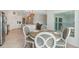 Bright dining area featuring a round table set, tile floors, and pendant lighting fixtures near the kitchen and living space at 14267 Heritage Landing Blvd # 1223, Punta Gorda, FL 33955
