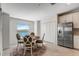 Cozy dining area with table, four chairs, view of the lake, stainless steel refrigerator, and white cabinets at 14267 Heritage Landing Blvd # 1223, Punta Gorda, FL 33955