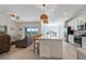 Open concept kitchen with stainless appliances, a large island, and a living space with outdoor access at 14267 Heritage Landing Blvd # 1223, Punta Gorda, FL 33955