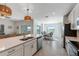Open concept kitchen area with stainless appliances and a view to the adjacent dining and living spaces at 14267 Heritage Landing Blvd # 1223, Punta Gorda, FL 33955