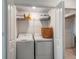 Functional laundry room equipped with a washer, dryer, and storage shelves at 14267 Heritage Landing Blvd # 1223, Punta Gorda, FL 33955