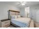 Relaxing main bedroom with a wood headboard, soft lighting, and a view of the ensuite bathroom at 14267 Heritage Landing Blvd # 1223, Punta Gorda, FL 33955