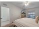 Bright main bedroom featuring soft bedding, a dresser with a TV, and a view to the ensuite bathroom at 14267 Heritage Landing Blvd # 1223, Punta Gorda, FL 33955