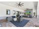 Inviting outdoor patio with comfortable seating, fireplace, and ceiling fans at 14267 Heritage Landing Blvd # 1223, Punta Gorda, FL 33955