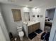 This bathroom features double sinks, new vinyl flooring, and modern fixtures for a spa-like experience at 15431 Orangeade Dr, Punta Gorda, FL 33955