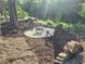 Cozy fire pit area near a lake, with stacked wood for fires at 15431 Orangeade Dr, Punta Gorda, FL 33955