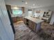 The bright kitchen has stainless appliances, modern cabinets and an island for ample prep and serving space at 15431 Orangeade Dr, Punta Gorda, FL 33955