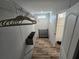 Spacious walk-in closet with shelving and hanging space for ample storage, new vinyl flooring, and natural light at 15431 Orangeade Dr, Punta Gorda, FL 33955