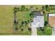 Aerial view of the property showcasing a meticulously landscaped lawn, inviting pool area, and a private driveway at 16232 Quesa Dr, Punta Gorda, FL 33955