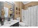 Bathroom features a shower and tub combination with a black vanity and artistic decor at 16232 Quesa Dr, Punta Gorda, FL 33955
