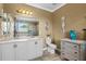 Bathroom features double sinks, a large mirror, and tiled floors with tasteful decorations at 16232 Quesa Dr, Punta Gorda, FL 33955
