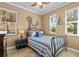 Charming bedroom features nautical decor, two bright windows, tile floor, and a comfortable bed at 16232 Quesa Dr, Punta Gorda, FL 33955