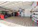 Spacious garage with a golf cart, epoxy flooring, and ample storage on shelves at 16232 Quesa Dr, Punta Gorda, FL 33955